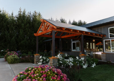 A roofed entrance of a building adorned with flowers